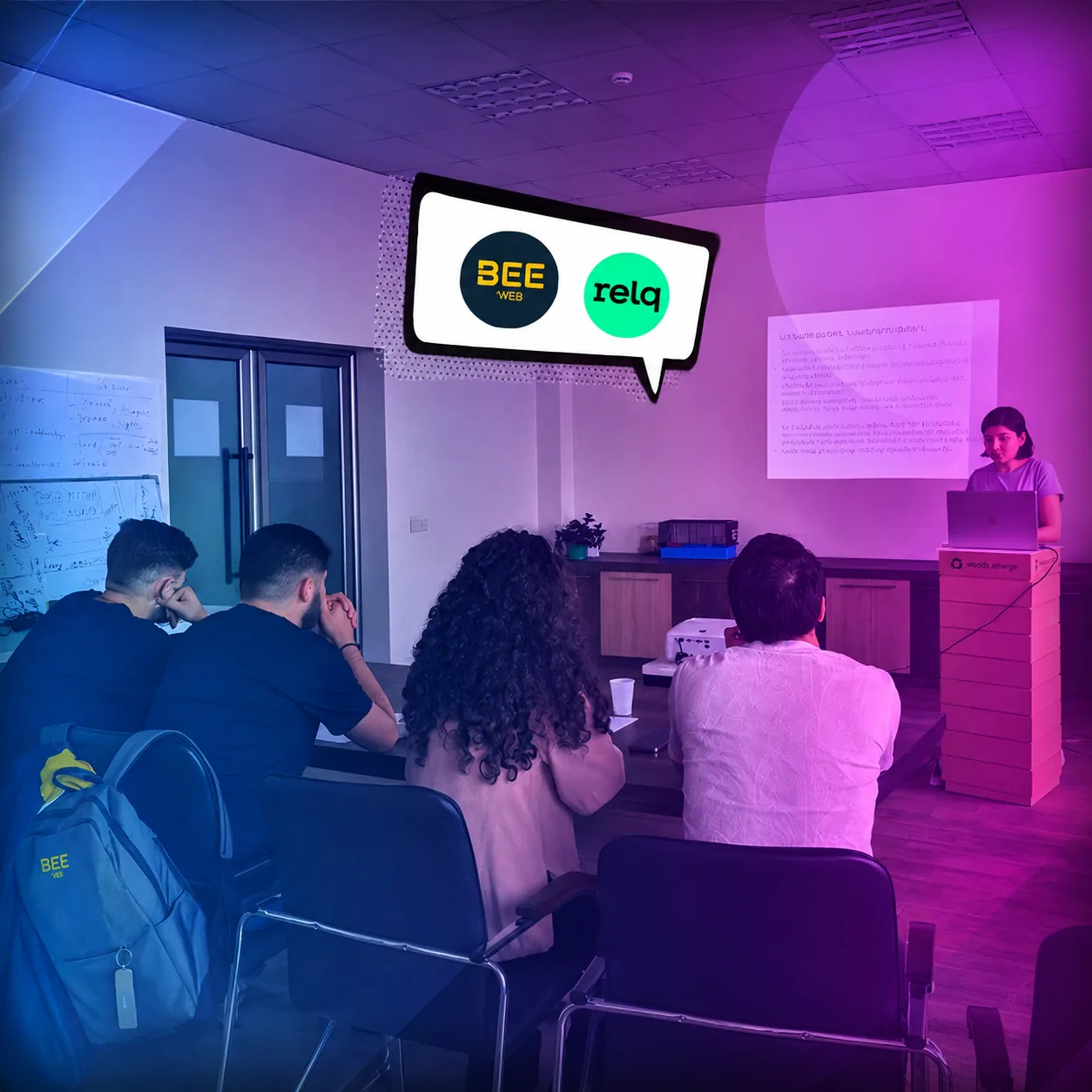 Participants seated during the Relq and BeeWeb assessment session, with both company logos on screen